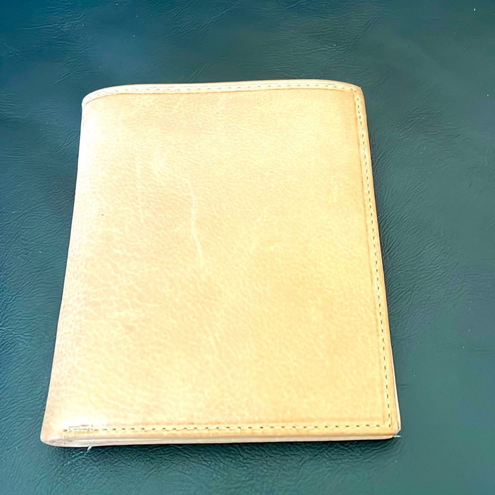 Genuine Leather Wallet. Brown and lays flat in your pocket. Can hold a lot.